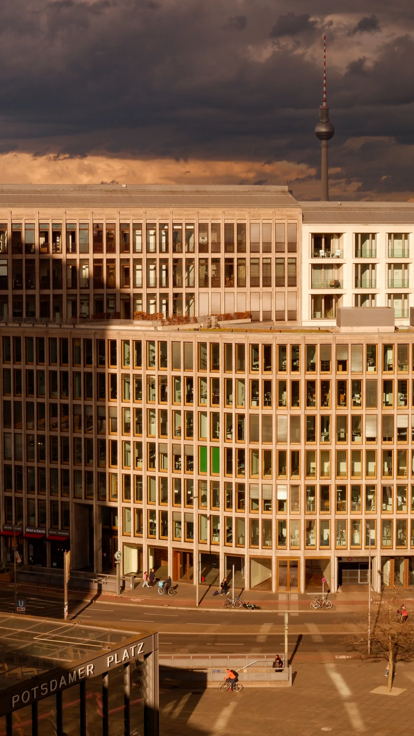 Potsdamer Platz buildings and the Berlin TV Tower beneath a dramatic sky