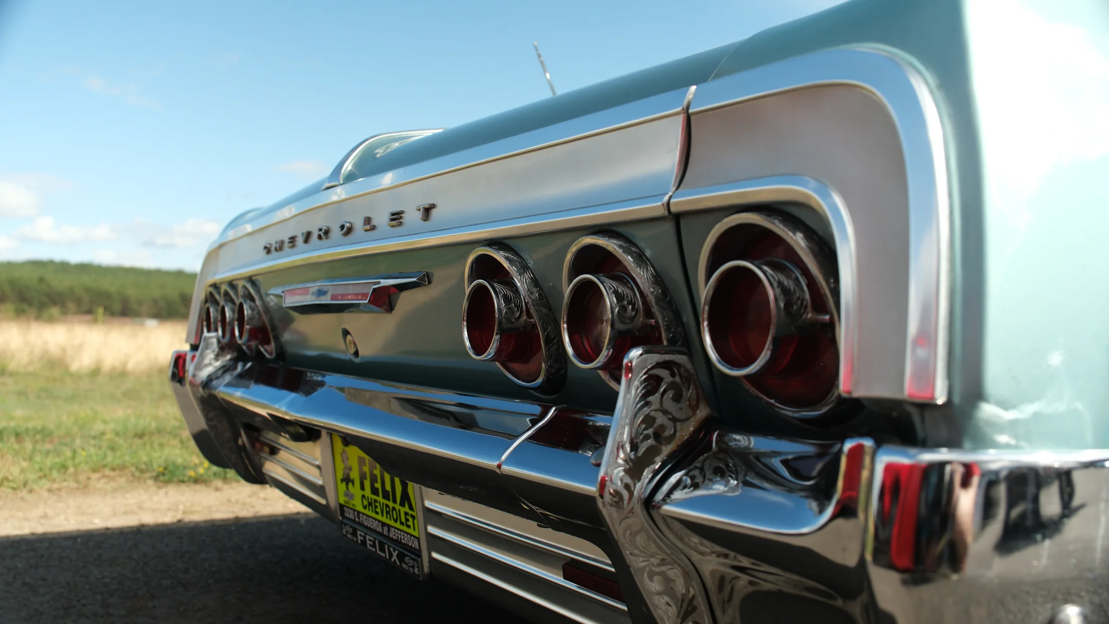 Close view of the rear lights and chrome trim of a classic Chevrolet Impala