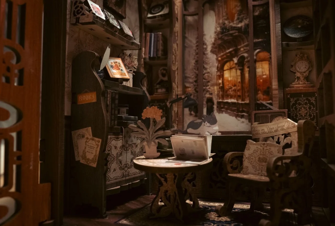 Detailed miniature interior with books, furniture and warm window light
