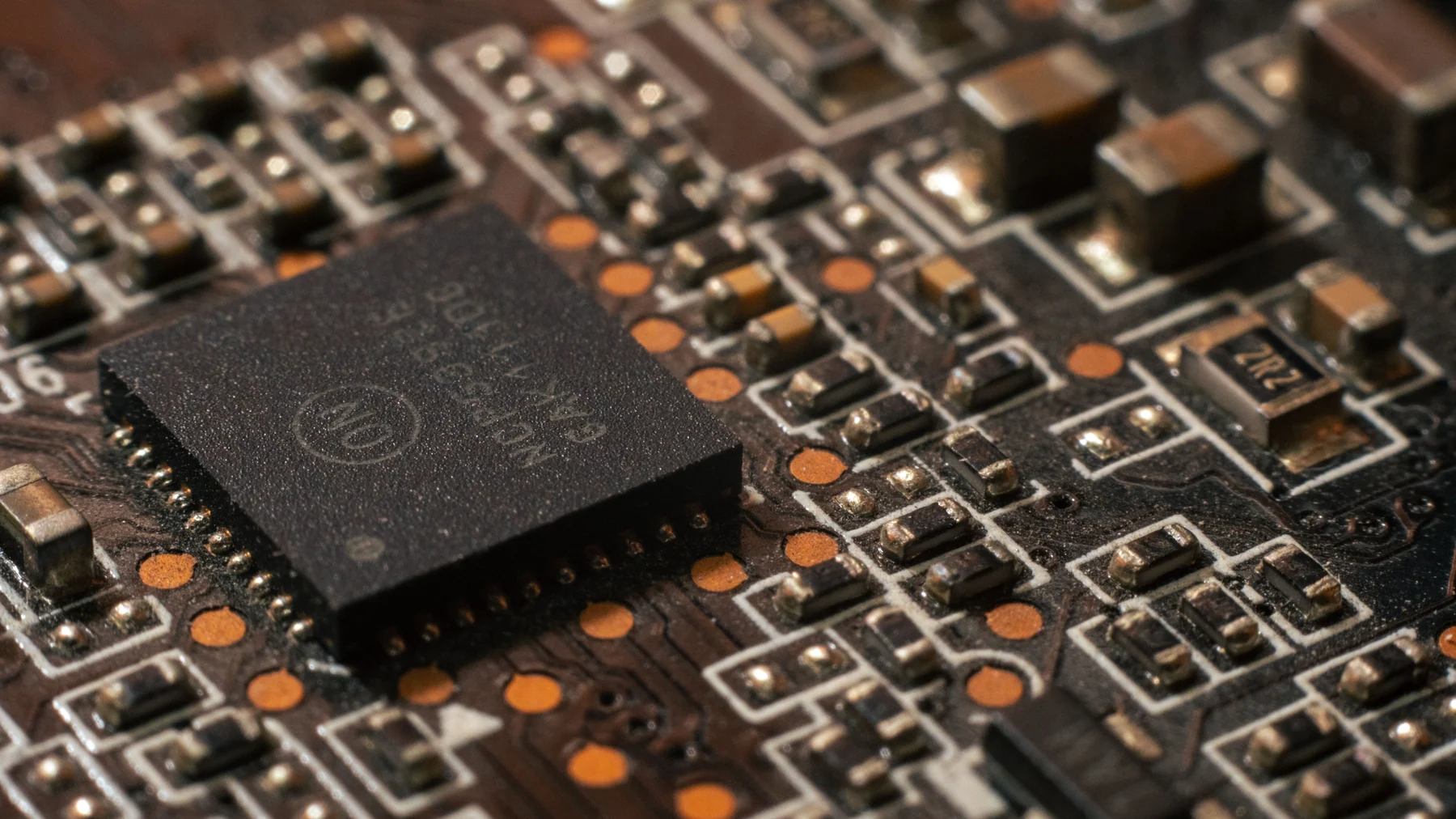 Detailed macro photograph of a computer circuit board and microchip