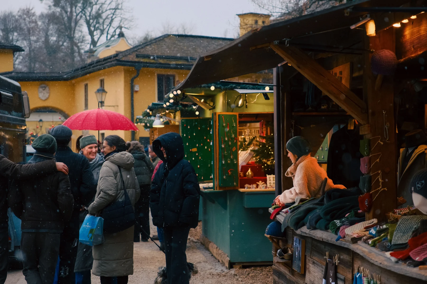 People meeting and shopping at a snowy winter market