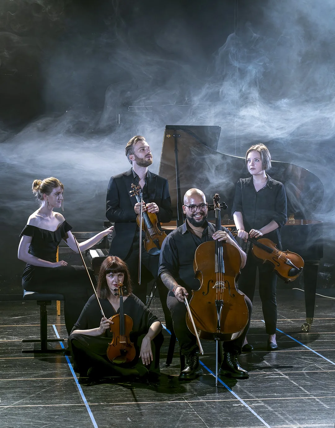 Noricum chamber ensemble posing together in atmospheric stage smoke